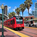 San Diego transit train with tracks and palm trees