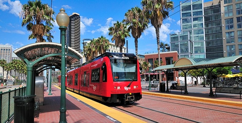 San Diego transit train with tracks and palm trees