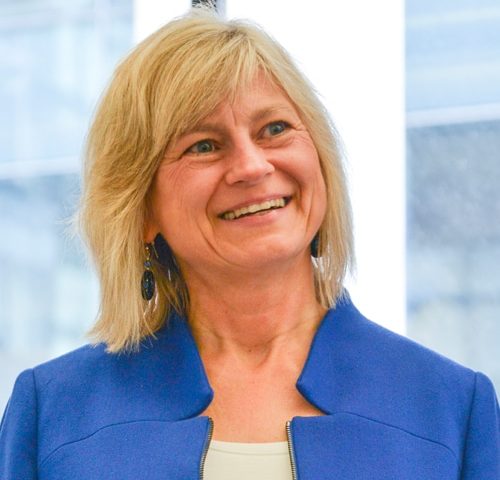 headshot Rita Fordiani in blue jacket and white shirt
