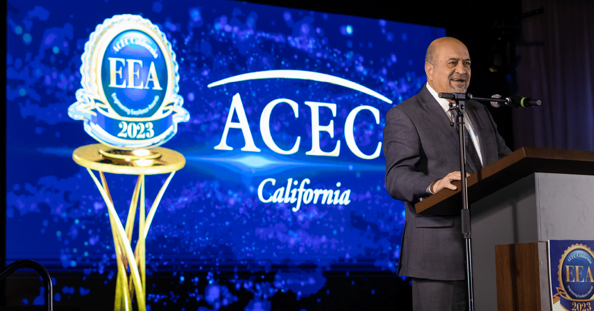 Kleinfelder's John Moossazadeh speaks at the podium on stage during the awards gala.