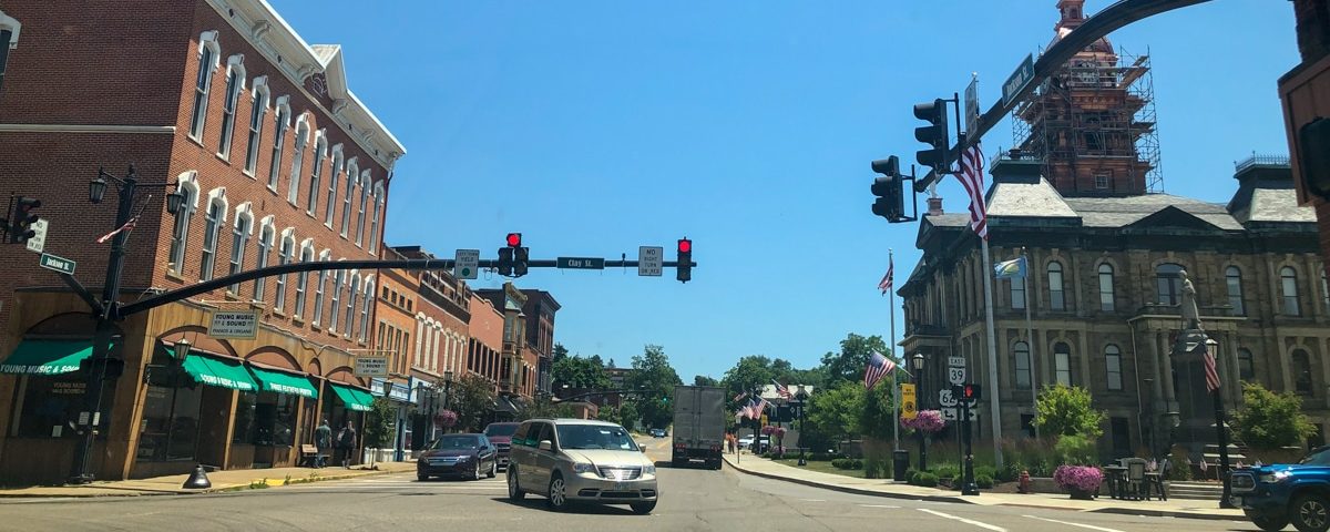 view of downtown Millersburg Ohio with street lights and cars