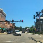 view of downtown Millersburg Ohio with street lights and cars