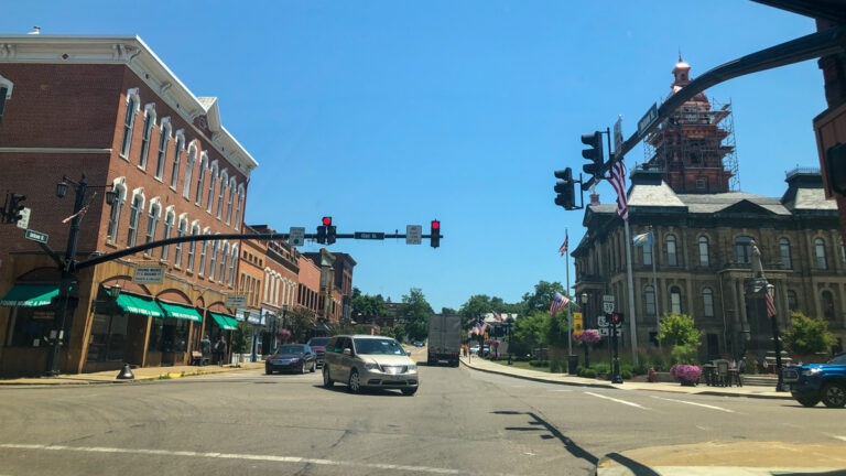 view of downtown Millersburg Ohio with street lights and cars