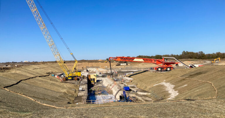 Heavy equipment with crane working on project site