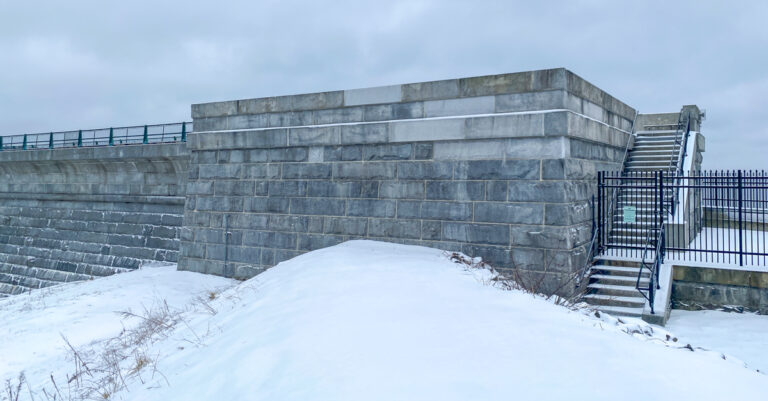 Wachusett Dam Reservoir bastion building in snow with gray sky