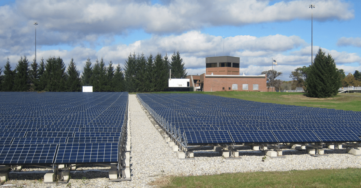 solar field with grass and building