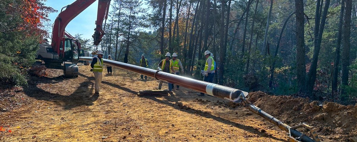 Field crew with HDD equipment and trees in dirt