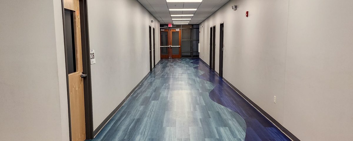 Metro Schools hallway with doors and blue floors