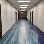 Metro Schools hallway with doors and blue floors