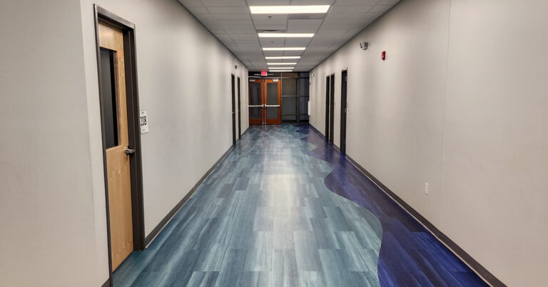 Metro Schools hallway with doors and blue floors