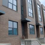 Townhomes in Perkins Homes development with construction and blue sky