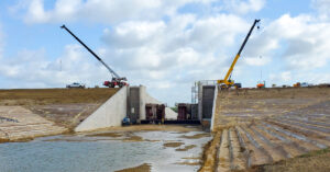 construction of the reservoir at Bois d'Arc Lake with cranes and trucks