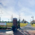 Piers Park 2 park entrance with sidewalk and grass