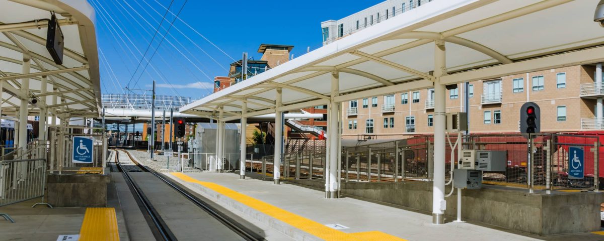 Commuter rail station outside with blue sky