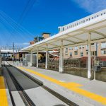 Commuter rail station outside with blue sky