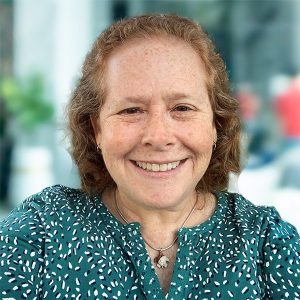 Lisa Daugherty headshot blue green background