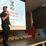 Kleinfelder Construction Services’ Public Relations team has partnered with California Operation Lifesaver (CAOL) to become champions of rail safety. Pictured: staff member presenting on stage.