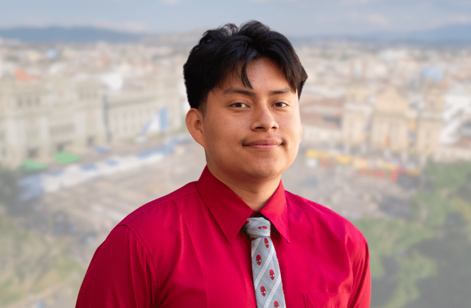 Headshot of Kevin Barrera Mejia with blurred image of Guatemala City in the background