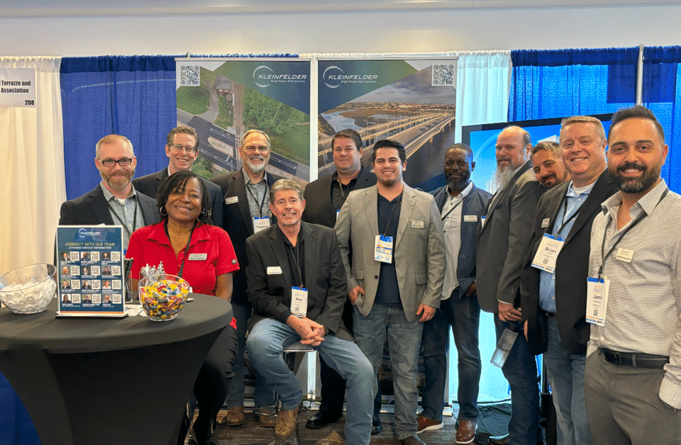 CMAA2024 conference attendees Tim Bayes, Rich Fitterer, Terri London, Thomas Fakner, Ken Bohannan, Scott Maloney, John Pollock, Derick London, Jeremy Mason, Sean Murphy, Brian Kisner, and Jamil Al Amamreh pose at booth