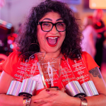 Joey Fernandez from Kleinfelder Construction Services' PR Team shows off the numerous awards the team won at the 2024 PRSA Awards