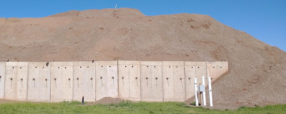 West Davis Corridor project test fill pile of dirt with concrete wall in front