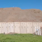 West Davis Corridor project test fill pile of dirt with concrete wall in front