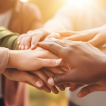 Stock image of hands reaching in depicting volunteering together