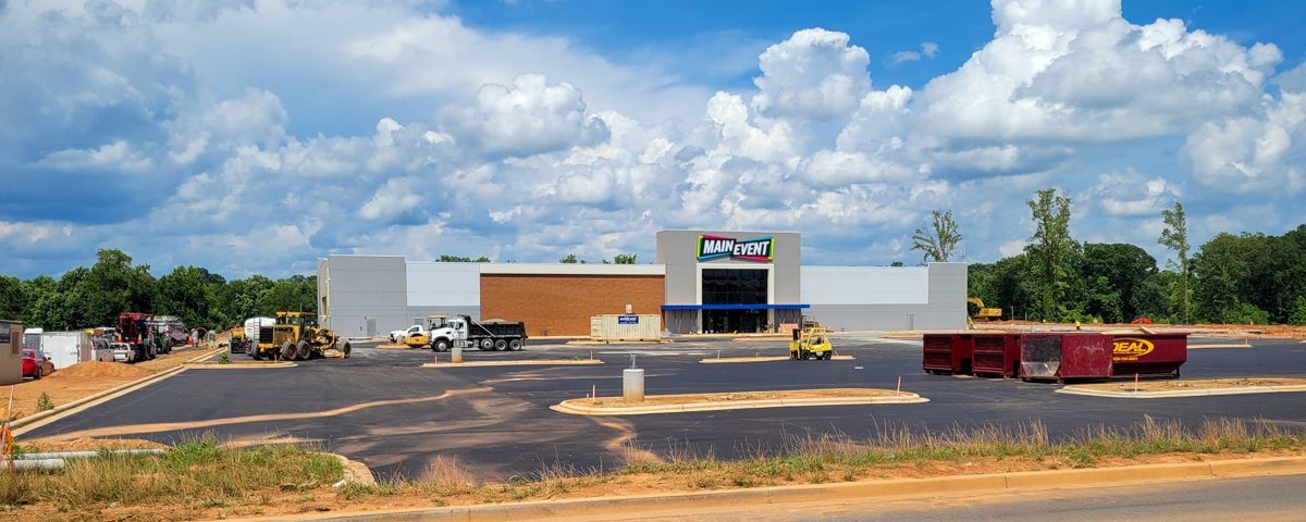main event building with pavement parking lot