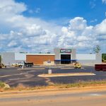 main event building with pavement parking lot