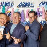 Kleinfelder project staff at event gala in front of logo branded backdrop