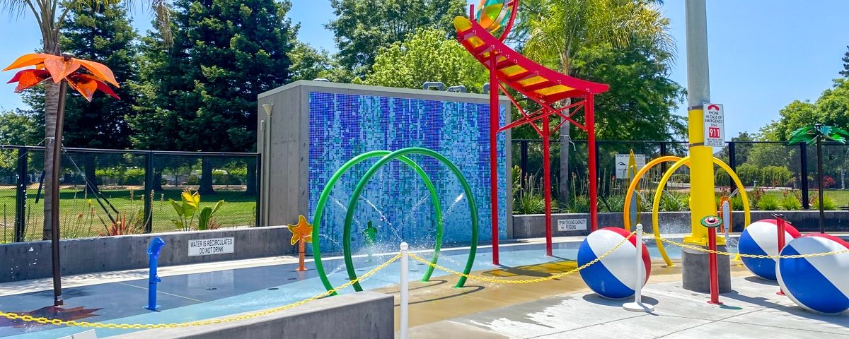 Aquatic center splash pad with colorful water features