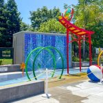 Aquatic center splash pad with colorful water features