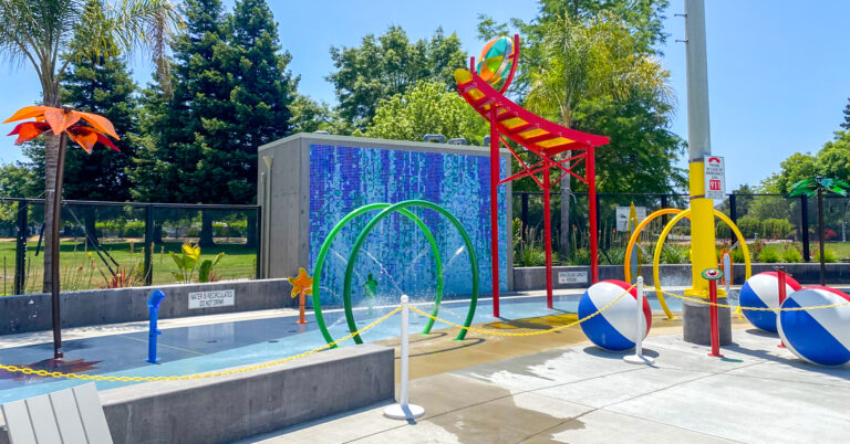 Aquatic center splash pad with colorful water features