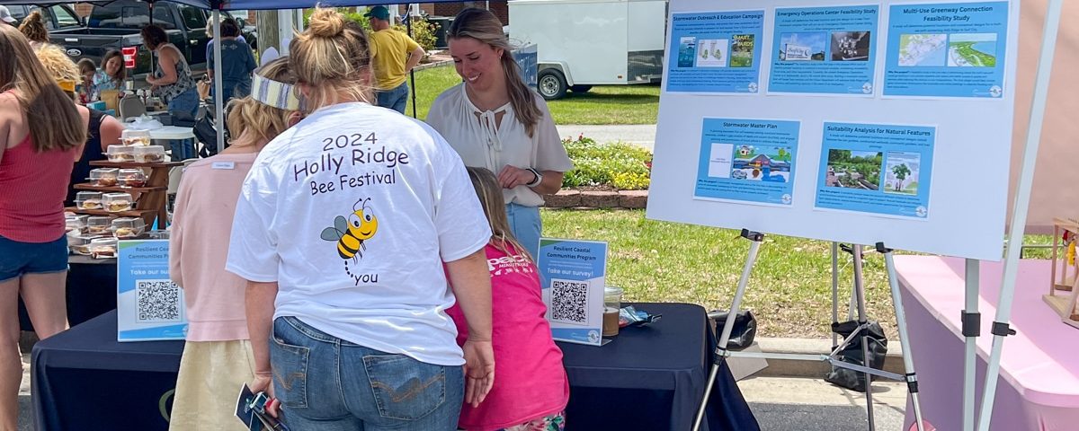 Holly Ridge North Carolina Bee Festival patrons at informational table