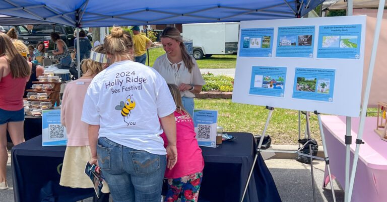 Holly Ridge North Carolina Bee Festival patrons at informational table