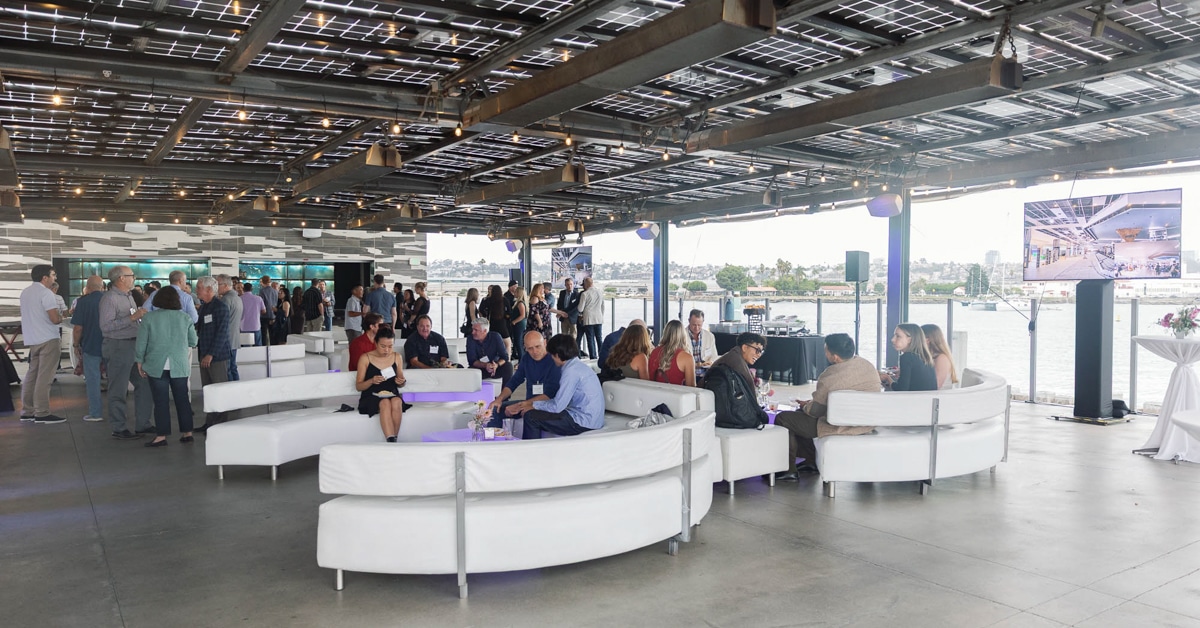 20251010-250925 Gensler-155 People enjoying event in semi-outdoor space overlooking San Diego