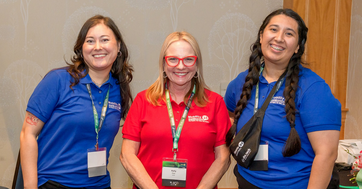 Three event volunteers pose for photo