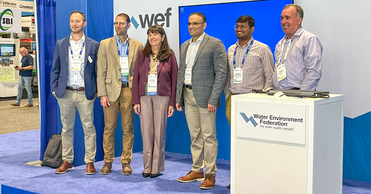 Speakers stand on stage at WEFTEC conference
