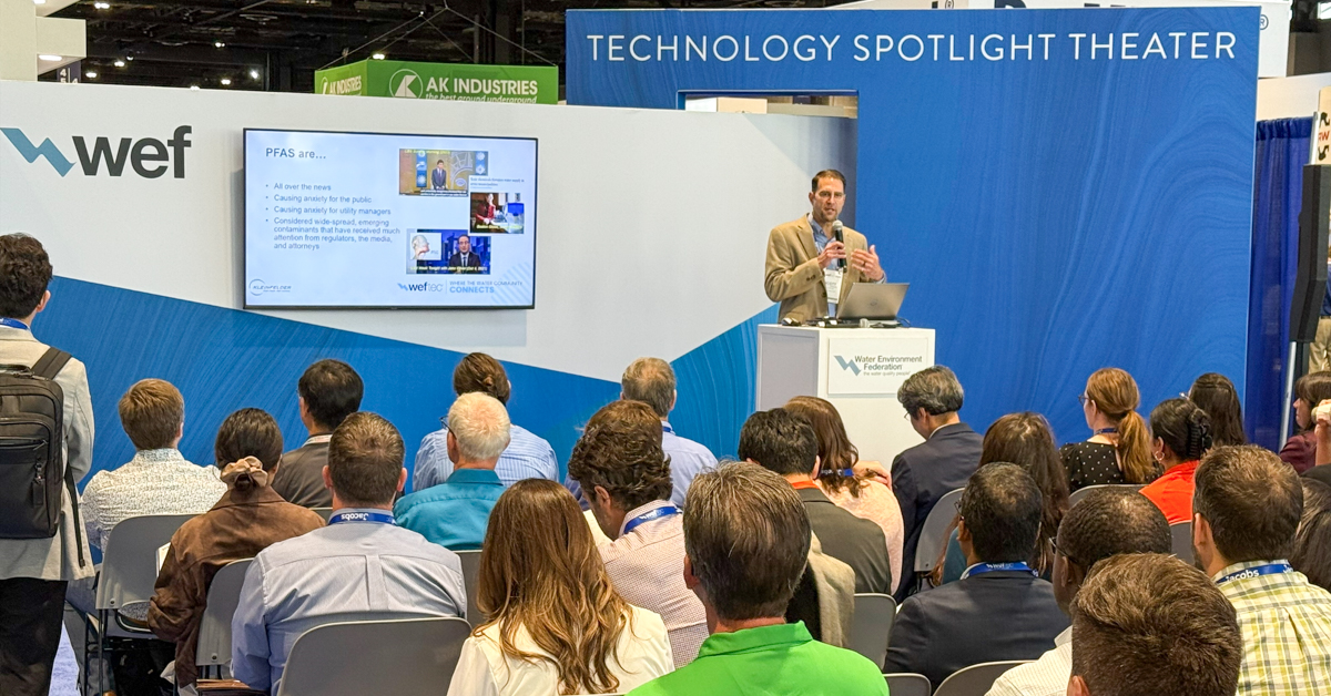 Scott speaking to audience at conference presentation