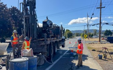 Washougal rail crossing elimination project three people standing on road with drilling equipment