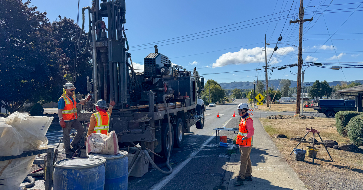Washougal rail crossing elimination project three people standing on road with drilling equipment