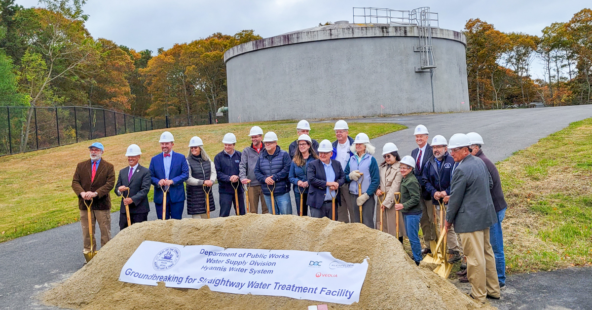 Straightway Water Treatment facility groundbreaking ceremony group of people with shovels and dirt in front of water tank