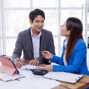 two people in business attire sitting at table
