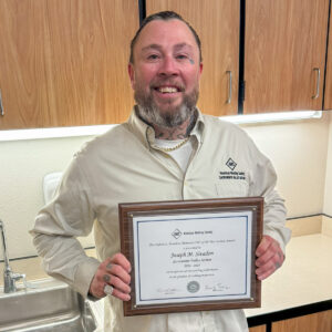 Joseph Sivadon with CWI award plaque