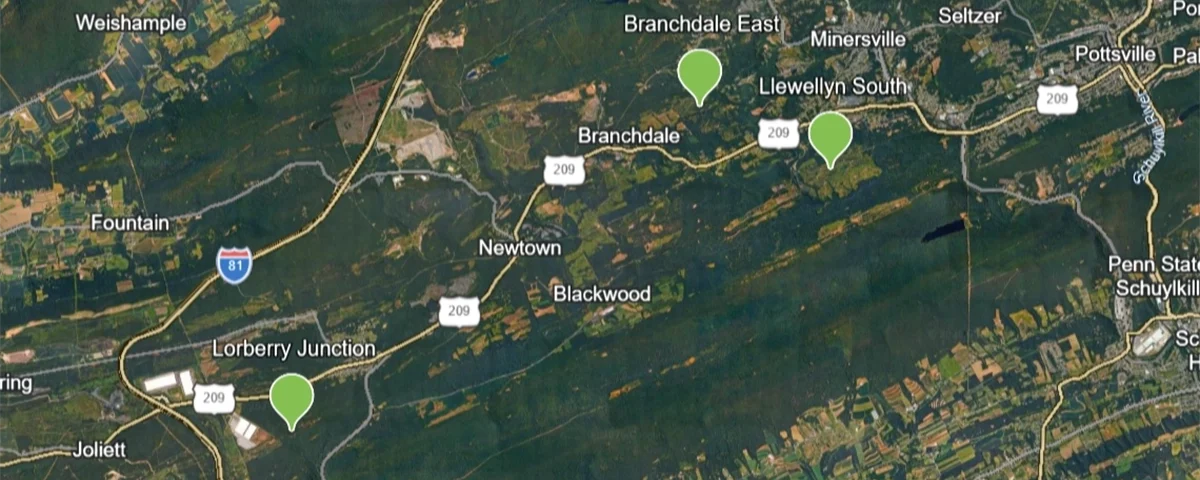 Topographic map with three green pins showing sites of Schuylkill County abandoned mine remediation sites