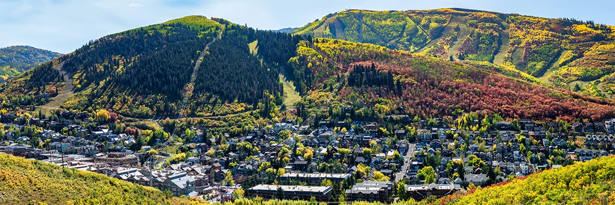 Aerial photo of Park City, Utah in the fall with lush mountains and town in valley