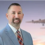 Jason Williams headshot with plane in background
